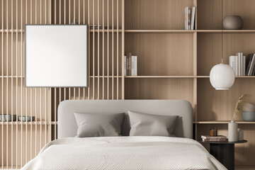 Bright bedroom interior with large bed, white empty poster