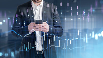 Businessman wearing formal suit is holding smartphone in his hands