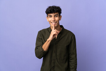 Young Argentinian man isolated on background showing a sign of silence gesture putting finger in mouth