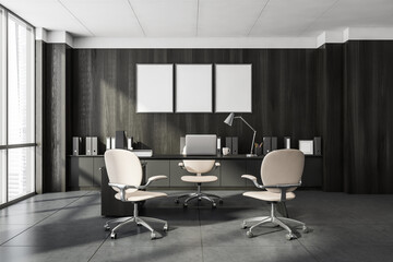 Dark office interior with three empty poster, panoramic window