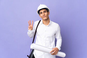 Young architect man isolated on background happy and counting three with fingers