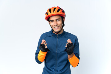 Young cyclist man isolated on background making money gesture