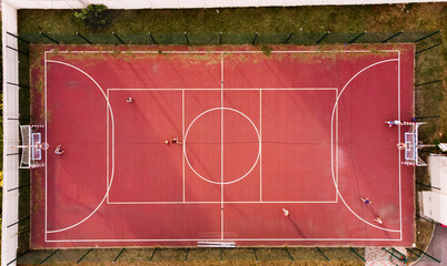 red basketball court. view from above. aerial photography. children.