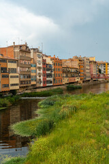 Girona medieval city, traditional colored houses on the dry river Onyar in summer, Costa Brava of Catalonia in the Mediterranean. Spain