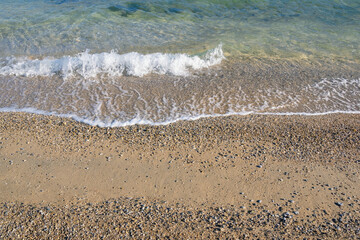 Natural background. Sunny beach on a calm day. Montenegro, Adriatic Sea