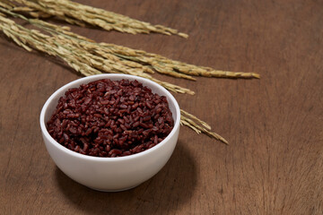 A rice bowl served on a wood table.