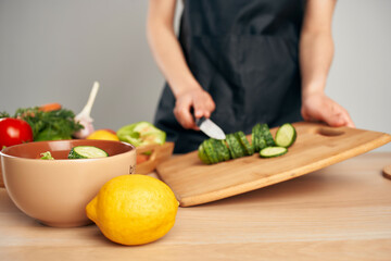 chef in black apron slicing vegetables housework cooking