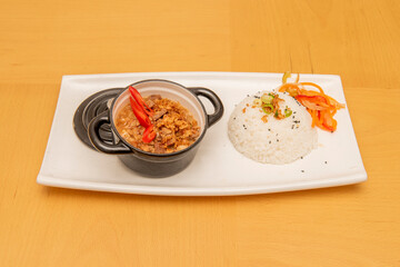 small black pie with Filipino bicol express stew with white rice and vegetables