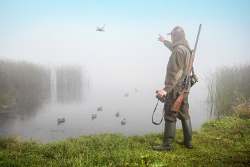 Man hunter with gun and binoculars. Hunting period concept.