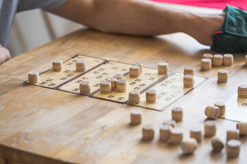 People play Russian loto on the table. Game of kegs with numbers