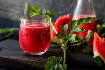 Summer drink. Cold watermelon juice with lime and mint on a wooden board. Berry-fruit smoothie.