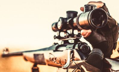 Hunt hunting rifle. Hunter is aiming. Hunter man. Shooter sighting in the target. Hunting period....