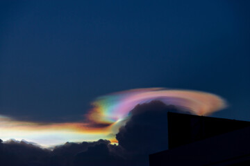 Beautiful iridescent cloud, Irisation. Skyscraper background.
