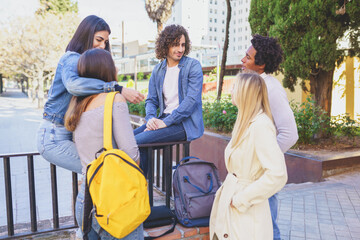 Obraz premium Multiracial group of young people talking together in the street.