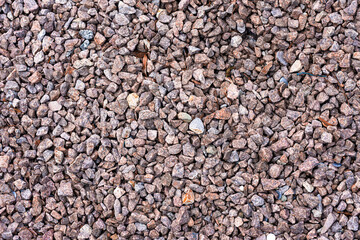 Background structure of reddish grey pebbles with sharp edges for garden and path design