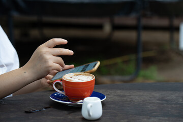Cup cappuccino on wooden table. 