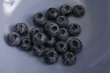 Close up of Blueberries in a blue bowl.