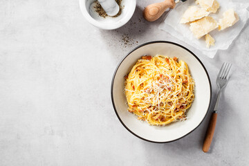 Dish of Spaghetti alla Carbonara, classic italian recipe of pasta with guanciale, egg yolk and parmesan cheese. Top view. Space for text