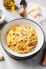 Dish of Spaghetti alla Carbonara, classic italian recipe of pasta with guanciale, egg yolk and parmesan cheese.