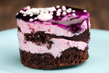 chocolate cake with cream covered with blueberry jam