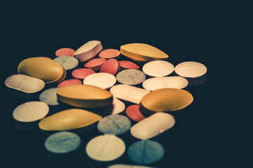 Pharmaceutical medicine pills in both tablets and capsules with the vintage retro picture style. Pharmacy theme and treatment medication as concept.	
