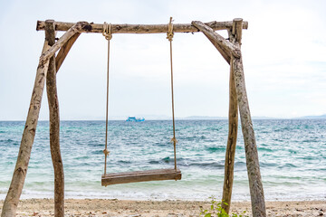 Nature in twilight period which including of sunrise over the sea and the nice beach. Summer beach with blue water and purple sky at the sunset.	
