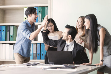 Manager and his team having meeting at meeting room in office.