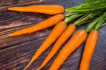 Bunch of carrots on the wooden table. Gardening summer bio concept.