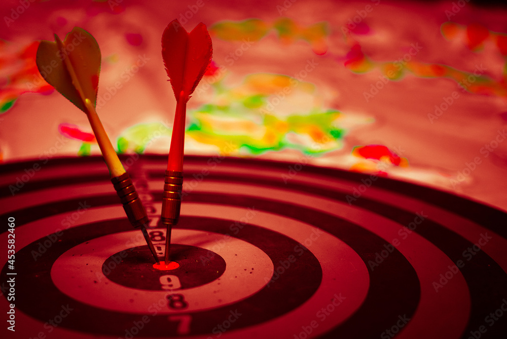 Poster close up shot of the dart arrow hit on bulleyes of dartboard to represent that the business reached 
