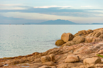 Nature in twilight period which including of sunrise over the sea and the nice beach. Summer beach with blue water and purple sky at the sunset.	
