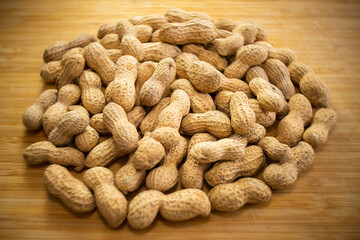 raw unprocessed peanuts on wooden background