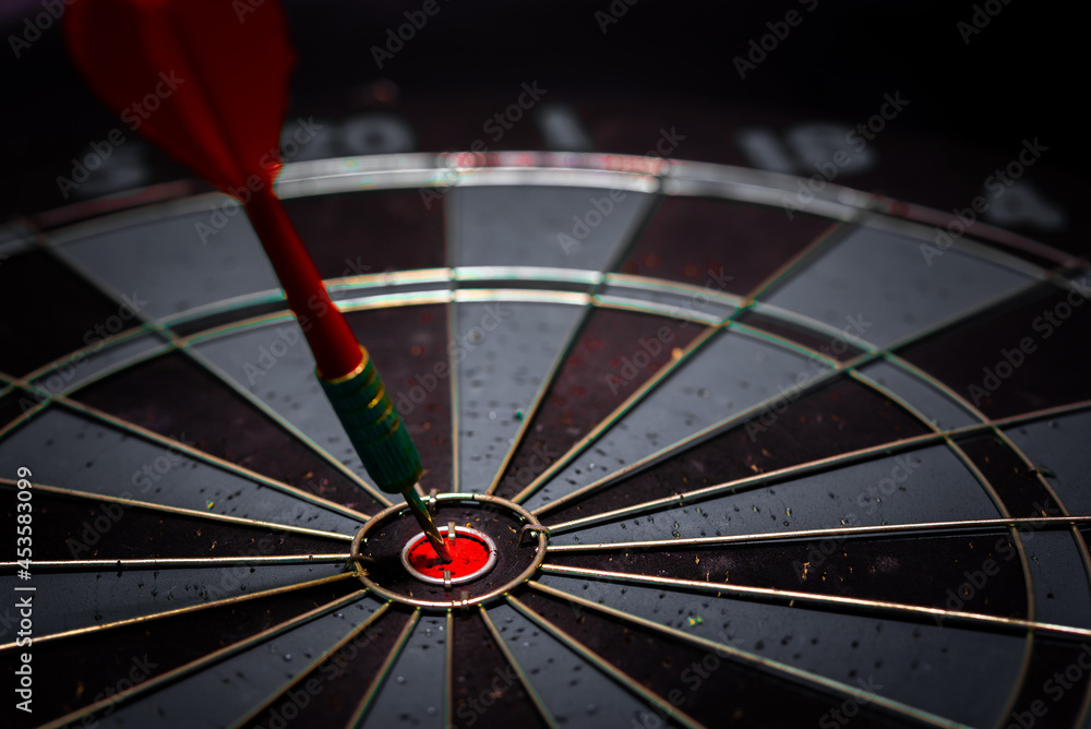 Aufkleber close up shot of the dart arrow hit on bulleyes of dartboard to represent that the business reached 