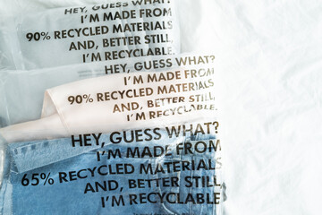 Clothes in plastic bag with tag recycled materials and recyclable. zero waste concept.