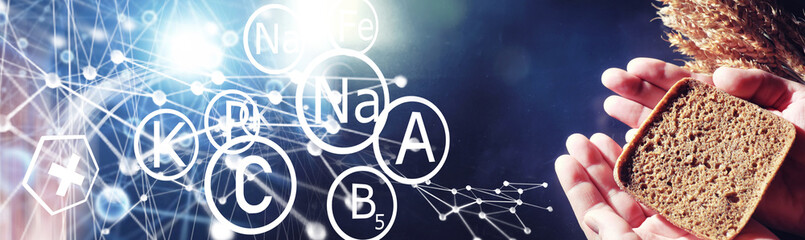 Obraz premium Fresh loaves of bread with wheat and gluten on a black table. Bakery and grocery concept. Fresh, healthy sorts of rye and white loaves food closeup. Fresh homemade bread with cereals.