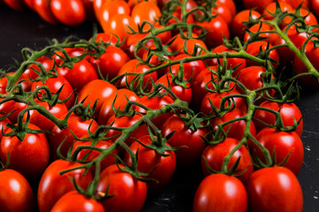 Tomatoes on wood background. Close-up of bio fresh vegetables. Group of summer tomatoes. Space for...