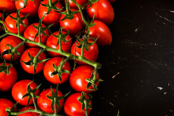 Tomatoes on wood background. Close-up of bio fresh vegetables. Group of summer tomatoes. Space for...