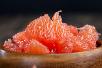 peeled red grapefruit divided into slices