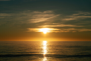 Obraz premium Beautiful sun rays by the ocean at sunrise