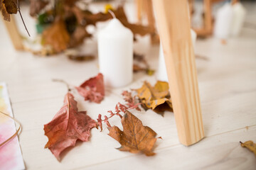 Close up of autumn arrangement with white candles
