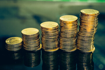 Gold coins stacks is representing riches and wealth management. Coin stack growing and find out the...