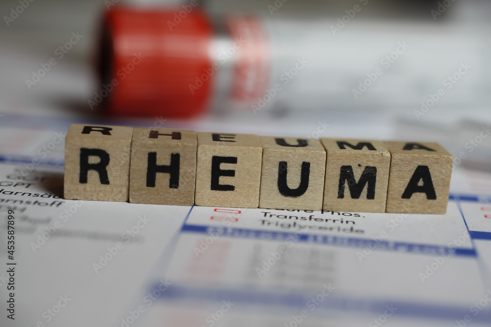 Wall mural viersen, germany - june 1. 2021: closeup of word rheuma on laboratory requisition slip with syringe 