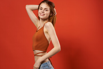 cheerful woman in a red t-shirt fashion hairstyle Glamor red background