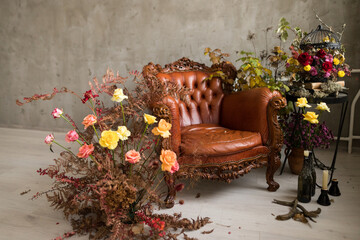 Fresh autumn arrangement with brown leather sofa