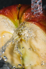 Apple under a stream of water