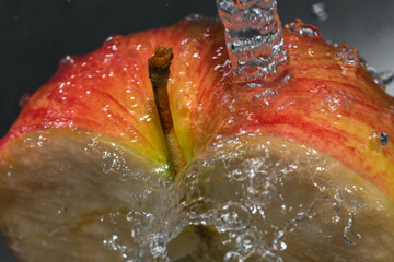 Apple under a stream of water