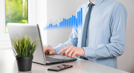Business man holding tablet and showing holographic graphs and stock market statistics gain profits. Concept of growth planning and business strategy. Display of good economy form digital screen.