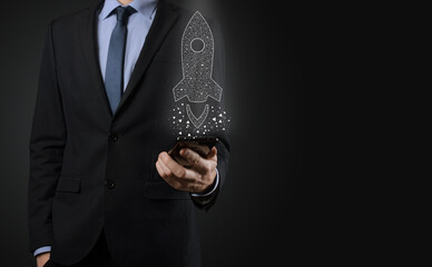 Startup business concept, Businessman holding icon transparent rocket is launching and soar flying...