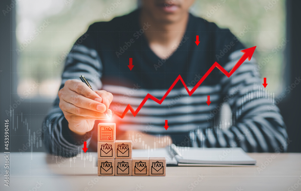 Wall mural Business losses on the tax on wooden cube concept, Business use pen touch wooden cubes and Red arrows fall to the ground, indicating the economic recession that will occur in 2022