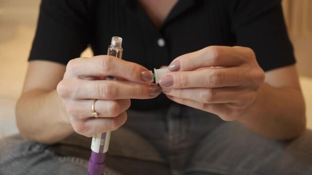 Woman using syringe pen for Hormone therapy treatment  Egg freezing. mature oocyte cryopreservation, FSH to stimulate the ovaries to produce more eggs. the initial process for fertility treatment. 