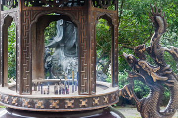 NEW TAIPEI CITY, TAIWAN - JANUARY 27, 2012:  Incense sticks burning inside the pot at Guan Dao Guan Ying Buddhist Temple